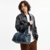 Compass-Tasche 35 aus regenerativem Baumwoll-Denim mit Anhängern