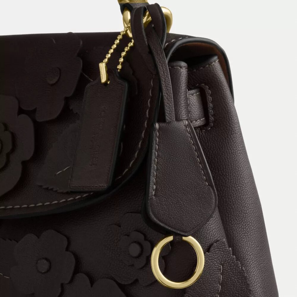 Emory-Handtasche mit Tragegriff und Blumenapplikation