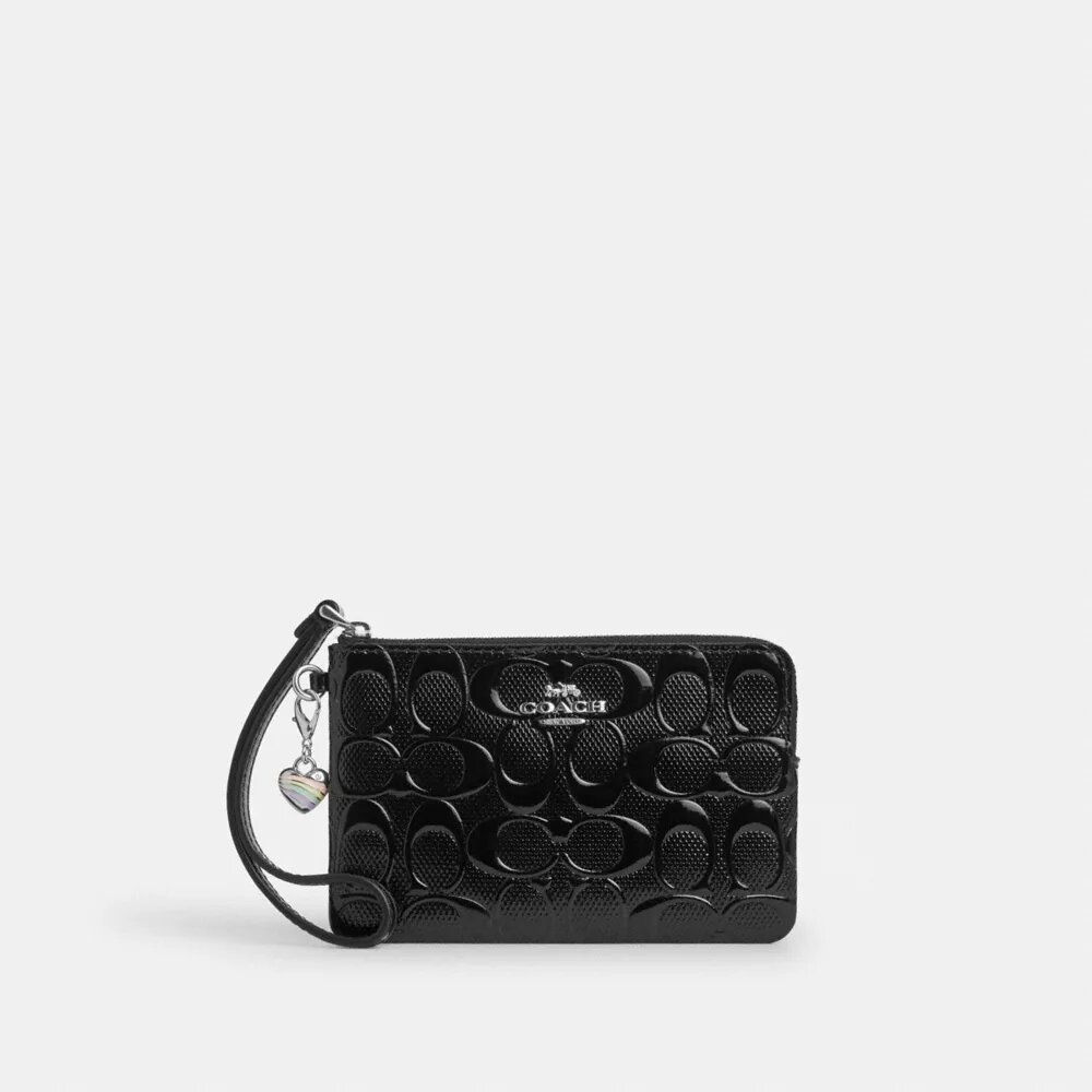 Handgelenktasche mit Reißverschluss an der Ecke aus Signature-Leder mit Herz-Anhänger