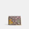 Mini-Geldbörse an einer Kette aus charakteristischem Jacquard mit Blumenstickerei