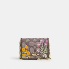 Mini-Geldbörse an einer Kette aus charakteristischem Jacquard mit Blumenstickerei
