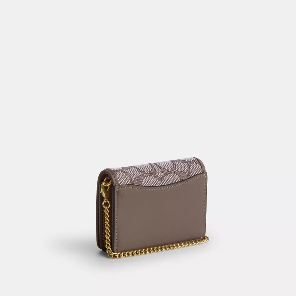 Mini-Geldbörse an einer Kette aus charakteristischem Jacquard mit Blumenstickerei