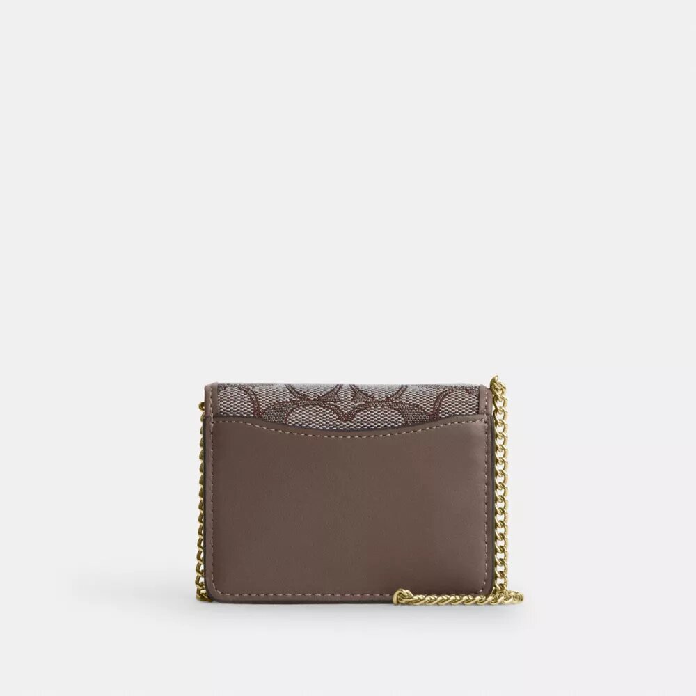 Mini-Geldbörse an einer Kette aus charakteristischem Jacquard mit Blumenstickerei