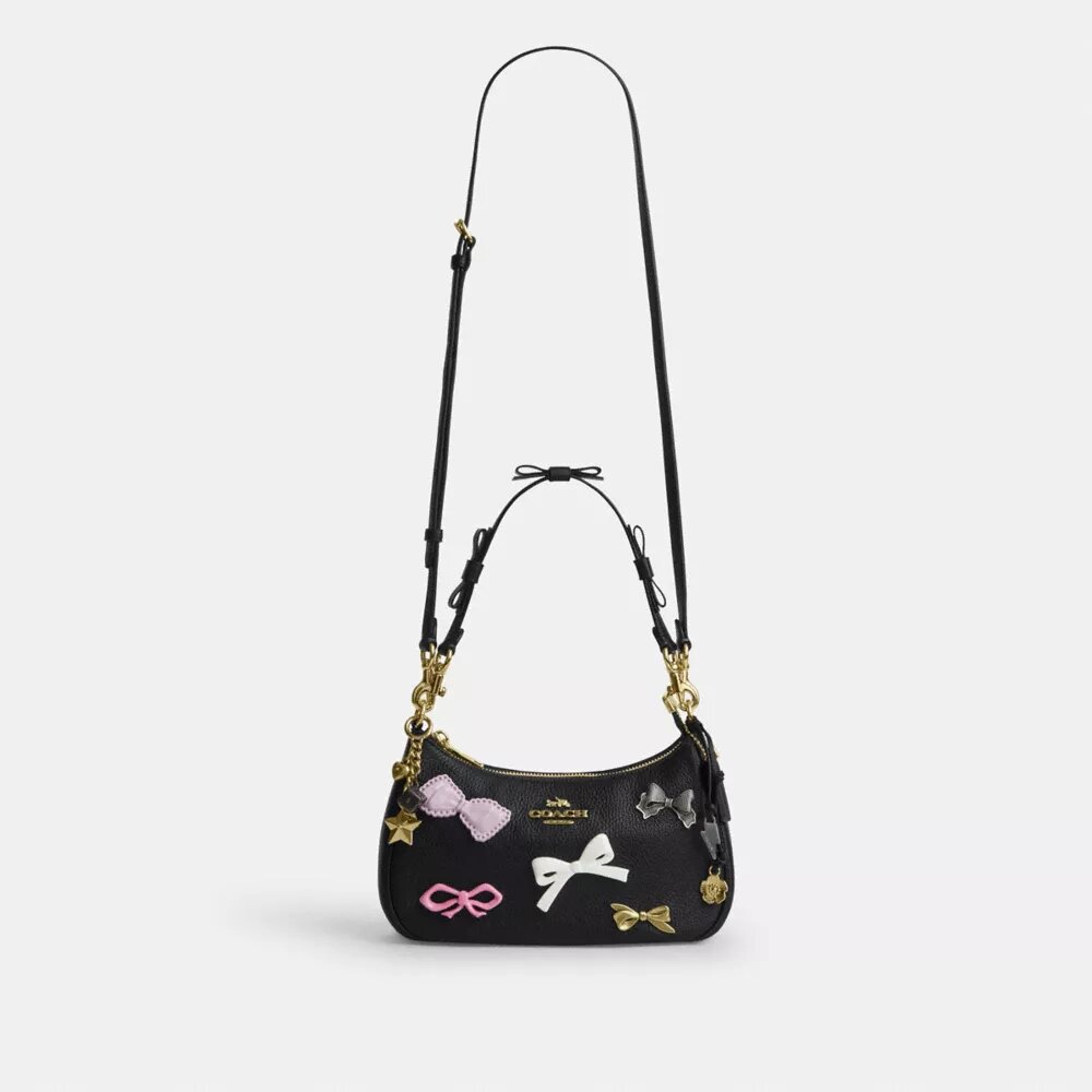 Teri-Schultertasche mit Schleifen und Anhängern