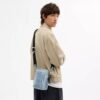 Tristan Umhängetasche 14 in „Loved“ Signature-Denim mit Anhängern