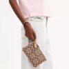 Unverzichtbare kleine Handgelenktasche aus unserem charakteristischen Jacquard